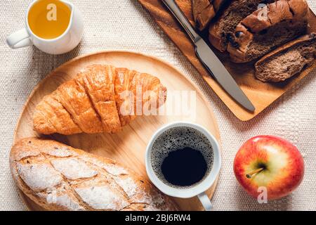 Traditional Breakfast Natural Vegetarian Food With Sourdough Bread, Coffee, Honey, Croissant on The Table., Homemade Freshly Baked French Sourdough Lo Stock Photo
