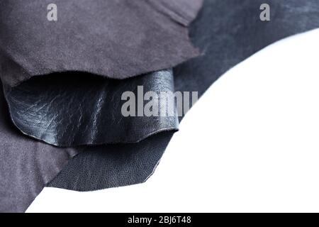 Black leather front and wrong side texture on white background, close-up Stock Photo