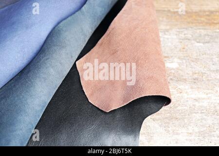 Ragged leather material wrong side, on the wooden table, close-up Stock Photo