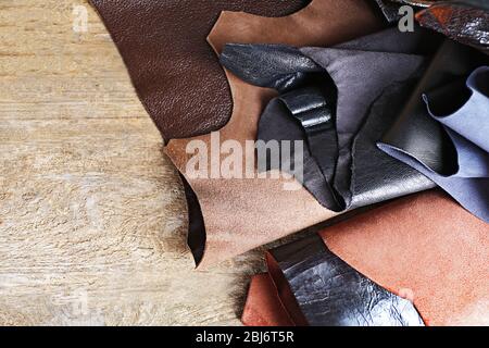 Ragged leather material wrong side, on the wooden table, close-up Stock Photo