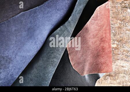 Ragged leather material wrong side, on the wooden table, close-up Stock Photo