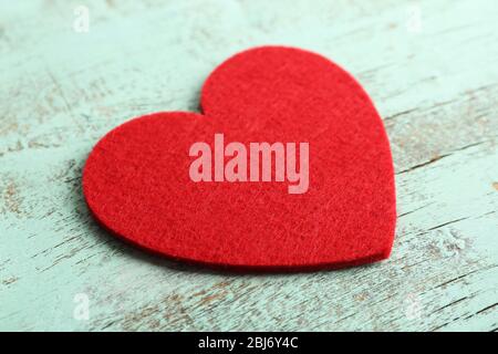 Red felt hearts on blue wooden background Stock Photo