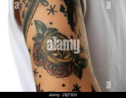 compass tattoo on male arm over white background 2bj73eh
