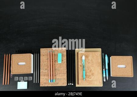 School supplies near blackboard, close up Stock Photo