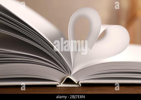 Heart from book pages on blurred background Stock Photo