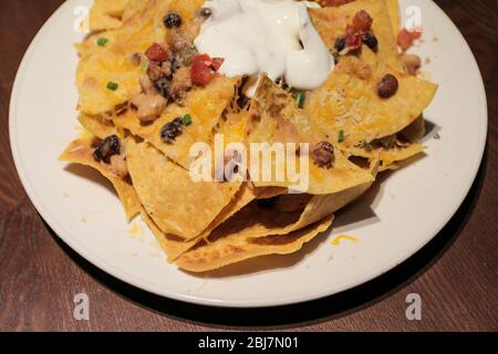Top view image of Macho Nachos on a wooden table. Stock Photo