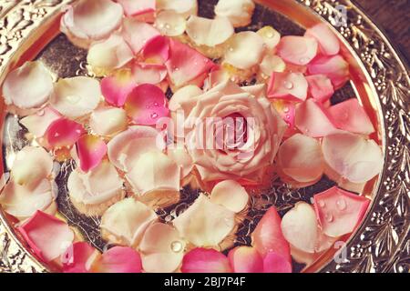 Pink and white rose petals in silver bowl, close up Stock Photo