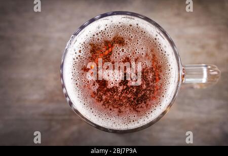 Top view of glass mug of light beer on wooden table, close up Stock Photo