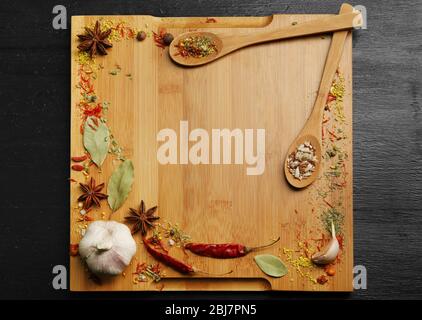 Spices frame on cutting board Stock Photo