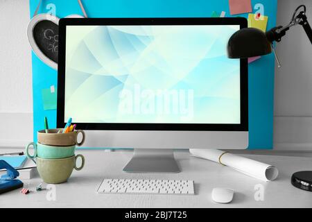 Stylish workplace with computer and interior decorations Stock Photo