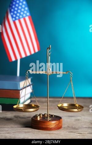 Justice scales with USA flag and books  on blue background Stock Photo