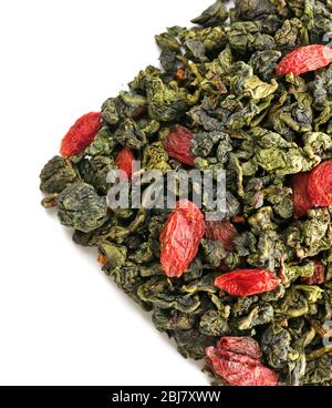 Pile of dry tea with goji berries, isolated on white Stock Photo