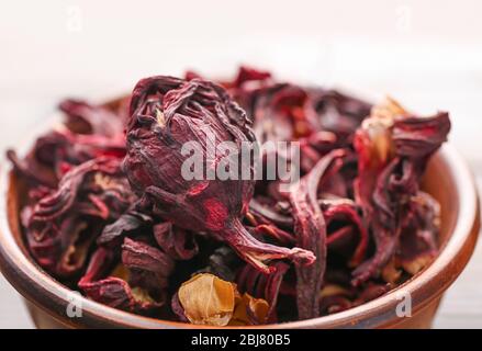 Hibiscus tea in a round bowl on wooden table, close up Stock Photo