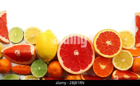 Fresh mixed citrus fruit including   lemons, limes, grapefruits, oranges and tangerines with slices, isolated on white background, top view Stock Photo