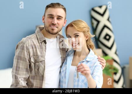 Young happy couple holding keys from their new apartment Stock Photo