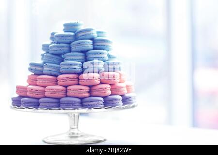 Many varicolored tasty macaroons on glass tray Stock Photo