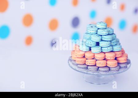 Many varicolored tasty macaroons on glass tray Stock Photo