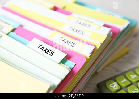 Folders with tax documents and calculator Stock Photo