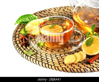Cup of tea with ginger on a wicker mat isolated on white Stock Photo