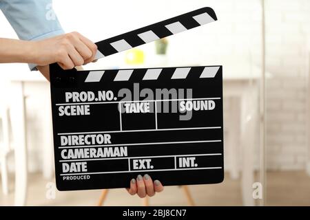 Woman hands holding film clapper, close up Stock Photo