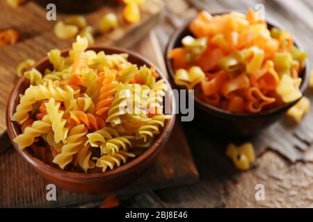 Different types of pasta on wooden background Stock Photo