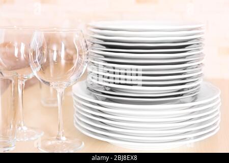 Clean dishes and glasses on wooden table. Stock Photo
