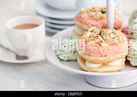 Cake stand with different sweets and tea Stock Photo
