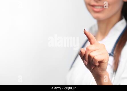 Young female doctor with pointing finger, close up Stock Photo