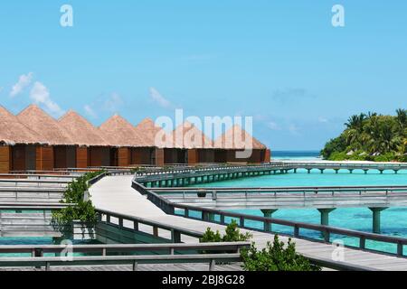 Water villas above blue ocean in Baros Maldives Stock Photo