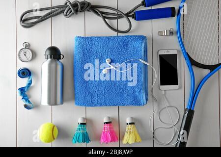 Sport equipment with mobile phone on white wooden background Stock Photo
