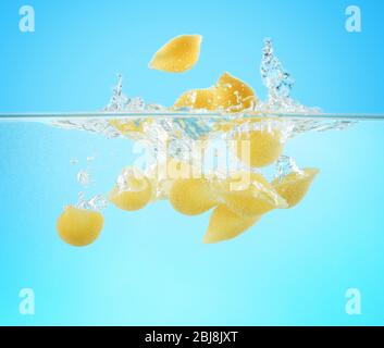 Falling pasta in water Stock Photo
