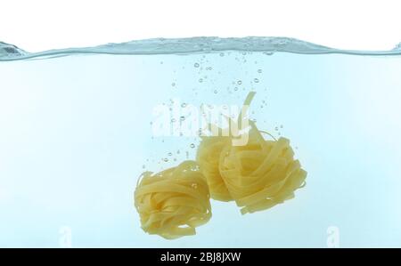 Falling pasta in water Stock Photo