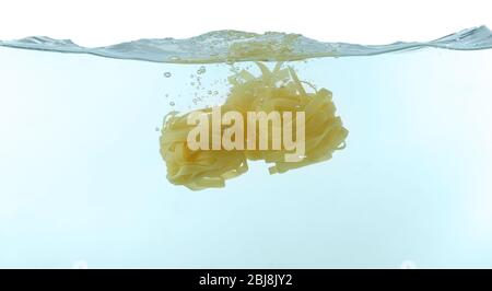 Falling pasta in water Stock Photo