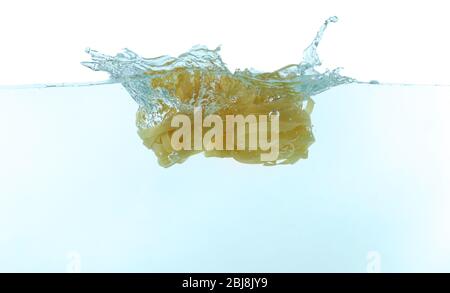 Falling pasta in water Stock Photo