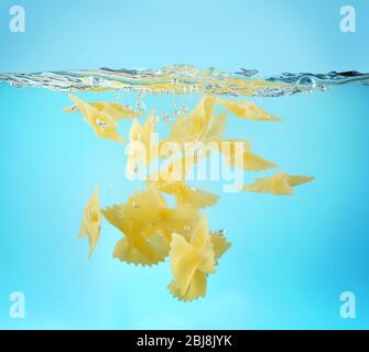 Falling pasta in water Stock Photo