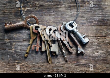 Bunch of old keys on wooden background Stock Photo