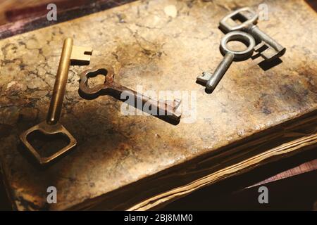 Four keys on background of old books Stock Photo