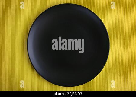 Empty plate on yellow textured background Stock Photo