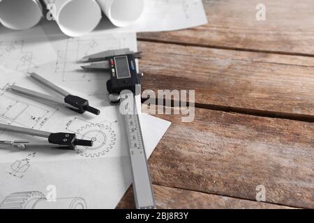 Set of engineering drawings with tools on wooden background Stock Photo