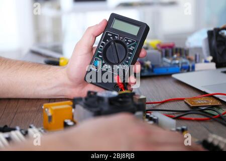 Male hands checking electronic hardware in service center Stock Photo