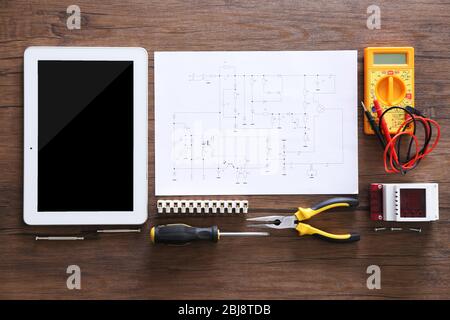 Electrical drawings, tablet and tools on wooden table, top view Stock Photo