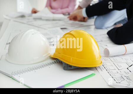 Helmets and blueprints on the office table Stock Photo