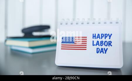 Notebook with printed text HAPPY LABOR DAY on wooden background Stock Photo