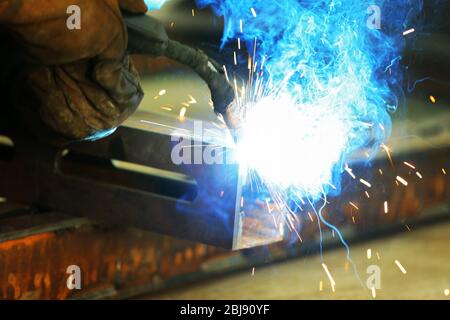 Man working with welding in the garage Stock Photo