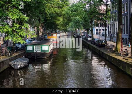 Canal view with houseboats in Amsterdam, Netherlands Stock Photo