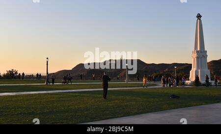 LOS ANGELES, CA/USA - FEBRUARY 6, 2020: Tourists on the grounds of the Griffith Observatory with the Hollywood Sign Stock Photo