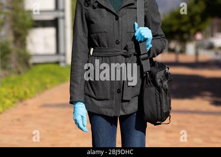 Caucasian woman wearing protective gloves against coronavirus Stock Photo