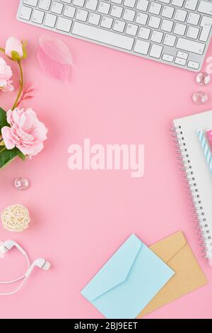 Blank notepad page in bullet journal on bright pink office desktop. Top view of modern bright table with notebook, stationery. Mock up, copy space Stock Photo