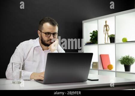 Tired freelancer working at computer in home office, Emotional, physical burnout Stock Photo