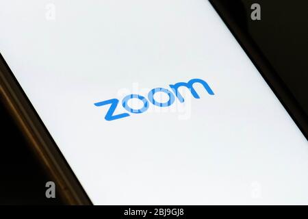 Zoom Video Communications app on the smartphone, videotelephony, video conferences and online chat services for meeting, working from home Stock Photo